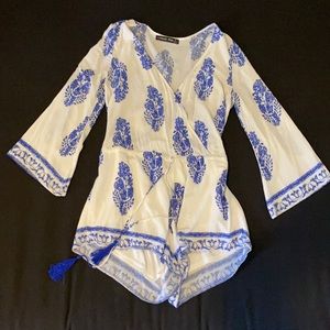 Printed white and blue longsleve romper with tassels